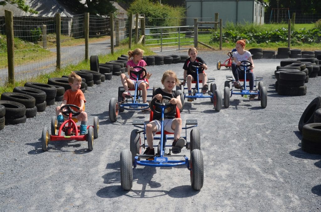 Five children playing with go-karts at Nore Valley Park