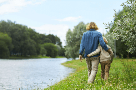 Father and son walking near a river
