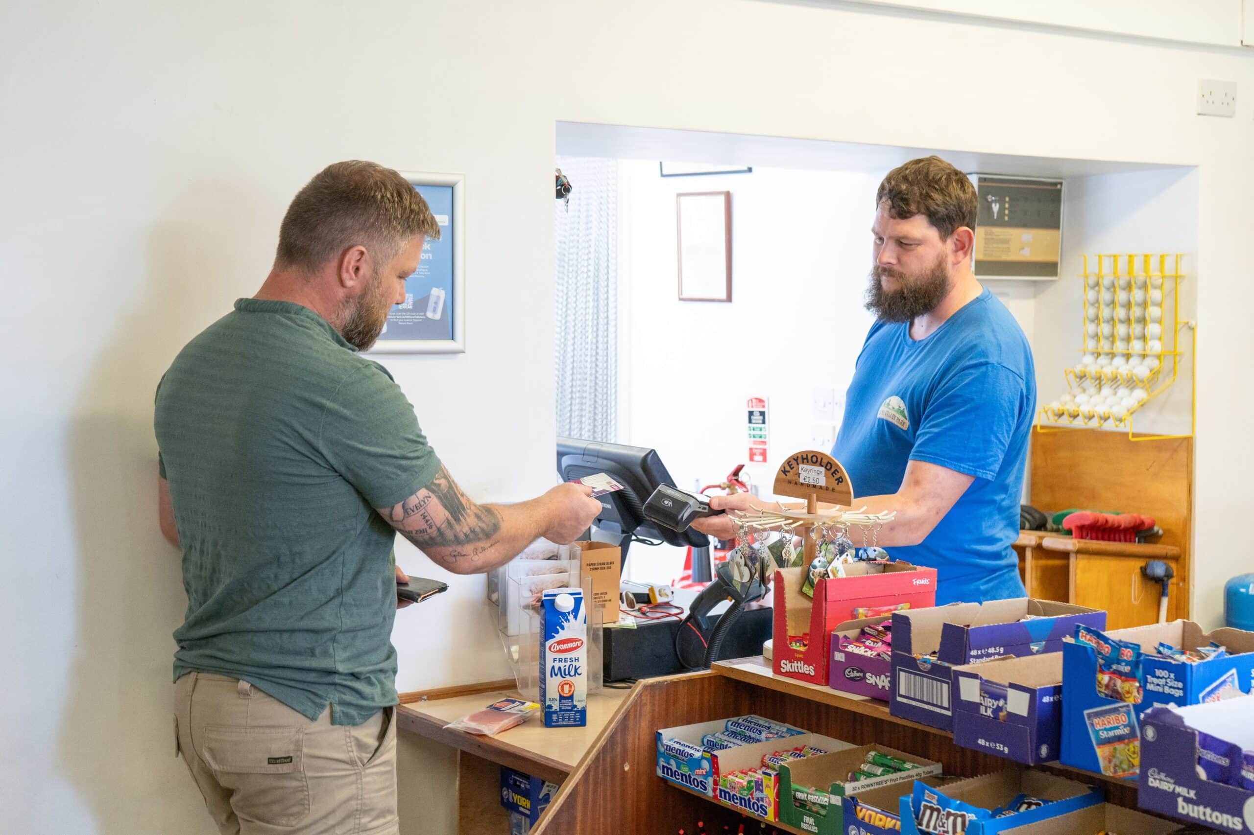 A Nore Valley Park staff member serving a customer in the shop
